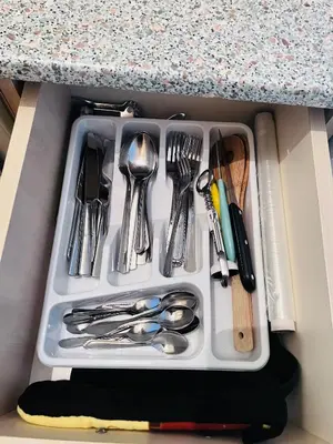a tray of silver utensils in a drawer at Elit 4 Apartments in Sunny Beach
