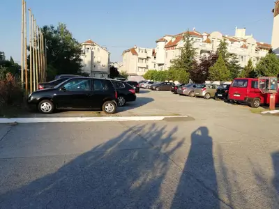 a shadow of a person taking a picture of a car at Apartments Bravo 1-Vichevi in Sunny Beach