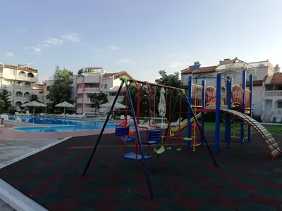 a playground in front of a swimming pool at Apartments Bravo 1-Vichevi in Sunny Beach