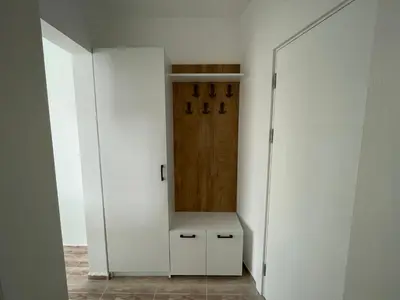 a closet with white walls and a wooden door at Студио Симона 5 първа линия море in Lozenets