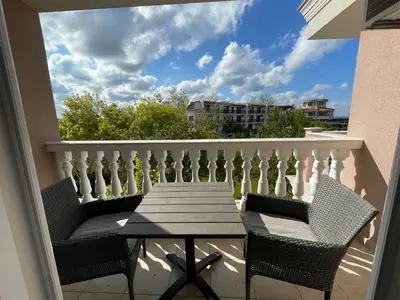 a table and chairs on a balcony with a view at Студио Симона 5 първа линия море in Lozenets