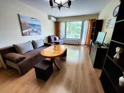 a living room with a couch and a table at Апартамент за гости , жк. Зорница, бл.36 in Burgas City