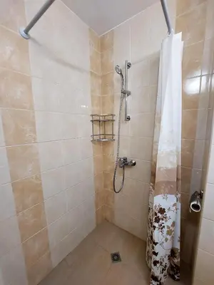 a bathroom with a shower with a shower curtain at Апартамент за гости , жк. Зорница, бл.36 in Burgas City