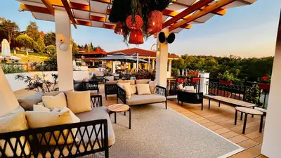 a patio with couches and chairs on a deck at Cozy Home Santa Marina Sozopol in Sozopol