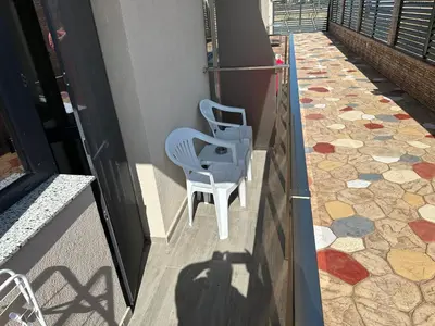 a blue chair sitting on the side of a building at Studios and Apartments Pomorie in Pomorie