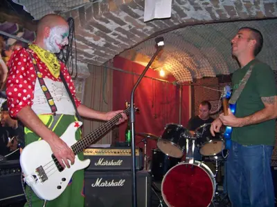 a man playing a guitar while another man plays drums at Yo Ho Hostel in Varna City
