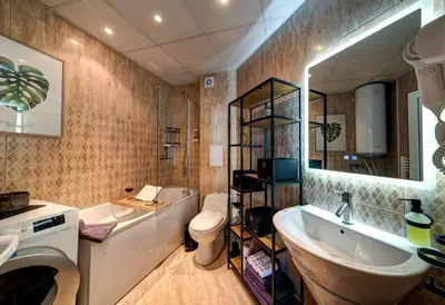 a bathroom with a sink and a tub and a toilet at Stylish Sea View Apartment 3 Min to Beach Balcony & Comfort in Pomorie