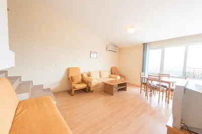 a living room with a couch and a table at GT Green Fort Beach Apartments in Sunny Beach