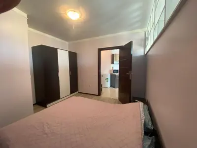 a bedroom with a bed and a door to a bathroom at SUNNY BEACH PLAZA 4-34 Apartment in Sunny Beach