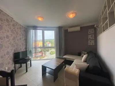 a living room with a couch and a window at SUNNY BEACH PLAZA 4-34 Apartment in Sunny Beach