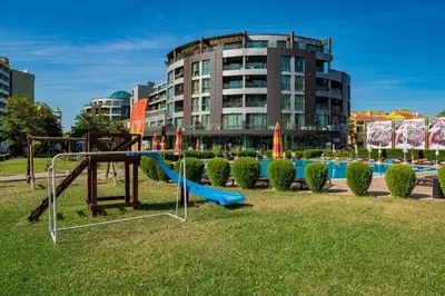 a playground with a slide in a park with a building at SUNNY BEACH PLAZA 4-34 Apartment in Sunny Beach
