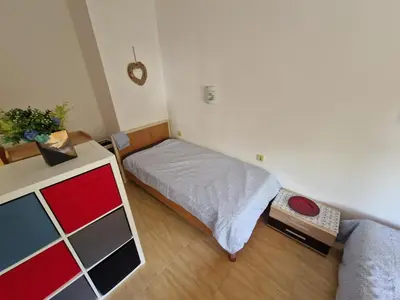 a small bedroom with a bed and a desk at Aqua Dreams A4, Sveti Vlas , A much sought after complex. in Burgas City
