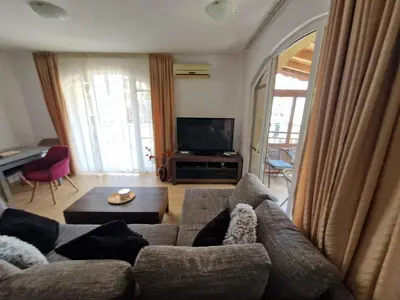 a living room with a couch and a tv at Aqua Dreams A4, Sveti Vlas , A much sought after complex. in Burgas City
