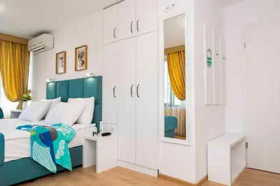 a bedroom with a bed and a mirror at Електра Апарт Бургас Electra Apart Burgas Elektra Bourgas in Burgas City