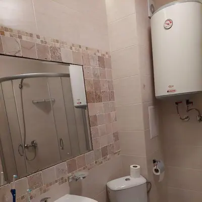 a bathroom with a shower and a toilet and a mirror at Dream Cascadas - Слънчев бряг in Sunny Beach
