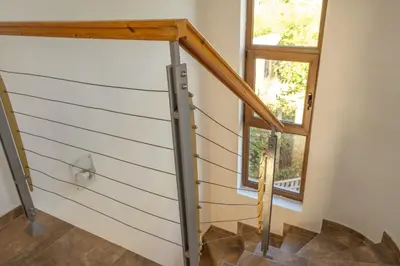 a pivot door in a house with a window at Indigo Villas in Pismenovo