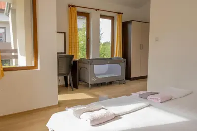 a room with a tv and a bed with towels at Indigo Villas in Pismenovo