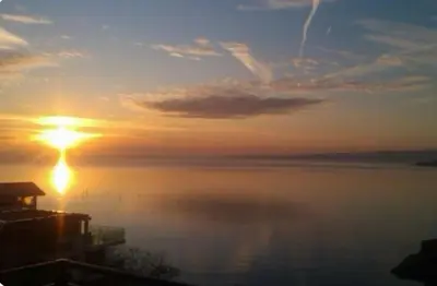 a sunset over the water with the sun in the sky at Вила Дафни - Villa Dafni in Sozopol