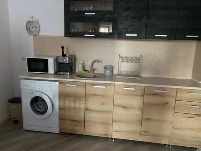 a kitchen with a washing machine and a microwave at Sozopoli Hills Apartment А4 in Sozopol