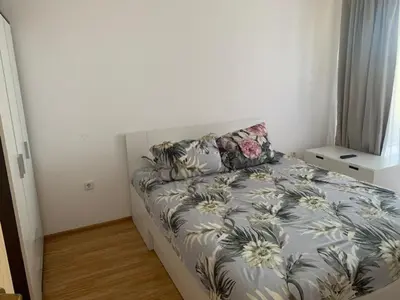 a bedroom with a bed with a floral comforter at Sozopoli Hills Apartment А4 in Sozopol