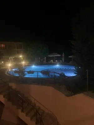 a large swimming pool at night with lights at Sozopoli Hills Apartment А4 in Sozopol