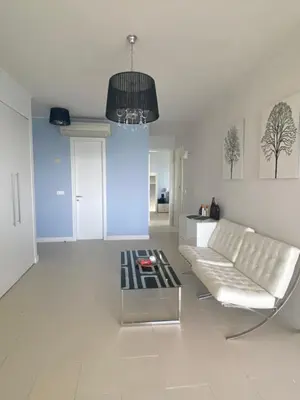 a living room with a white couch and a table at Private Apartments in Yoo Bulgaria Complex in Obzor