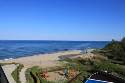 a view of a beach with a playground at Private Apartments in Yoo Bulgaria Complex in Obzor