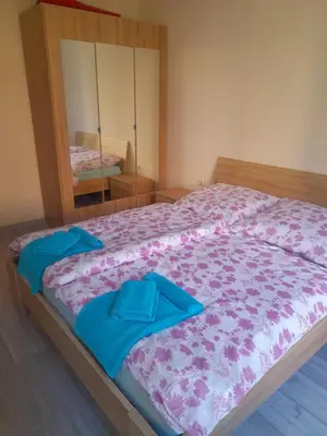 a bedroom with a bed with blue towels on it at YASSEN APARTMENT CLOSE TO SEA And Central in Sunny Beach