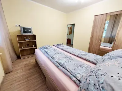 a small bedroom with a bed and a tv at Апартамент за гости, ж.к. Зорница , бл.9 in Burgas City