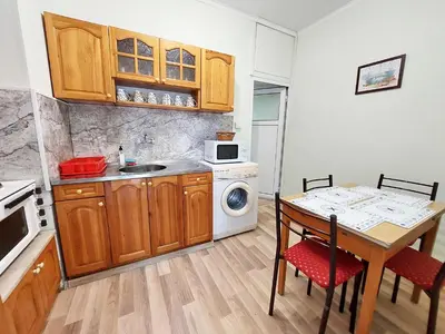 a small kitchen with a table and a microwave at Апартамент за гости, ж.к. Зорница , бл.9 in Burgas City