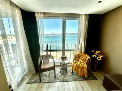 a room with a balcony with a view of the ocean at One Bedroom Private Apartment Paradiso B 501 in Nesebar