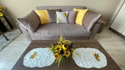 a living room with a couch and a table with flowers at One Bedroom Private Apartment Paradiso B 501 in Nesebar