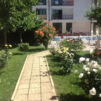 a path in a garden with flowers and a building at SannyBeach AmberBeach Apartment Bulgaria A14-1 in Sunny Beach