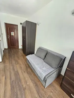 a couch in a living room with a wooden floor at SannyBeach AmberBeach Apartment Bulgaria A14-1 in Sunny Beach