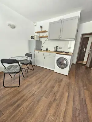 a kitchen with a washing machine and a table and chairs at SannyBeach AmberBeach Apartment Bulgaria A14-1 in Sunny Beach