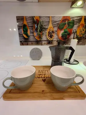 two cups on a cutting board with a happy thanksgiving sign at Нощувки Свети Влас Комплекс Амфора , студио 704 in Sveti Vlas