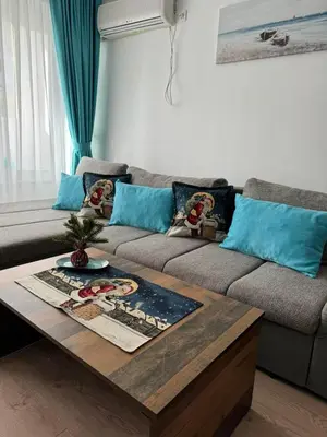 a living room with a couch and a coffee table at Deni's Apartment by the sea – Burgas in Burgas City