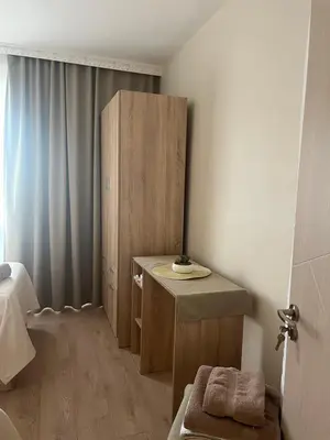 a small bathroom with a wooden cabinet in a room at Deni's Apartment by the sea – Burgas in Burgas City