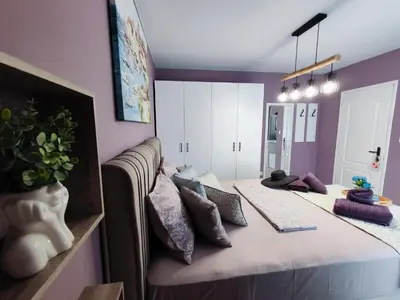 a room with a bed with pillows on it at AMORE Obzor in Obzor