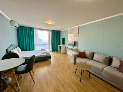 a living room with a couch and a bed at Apartments in Panorama Beach Vigo Nessebar in Nesebar