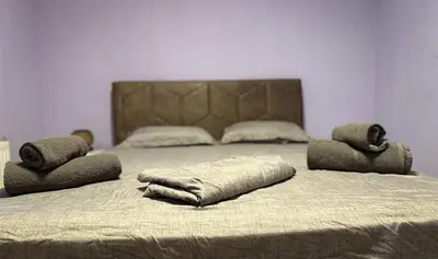 a large bed with two pillows on top of it at Апартамент Joy in Varna City