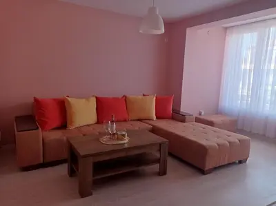 a living room with a couch and a coffee table at Apartament Lili Sozopol in Sozopol