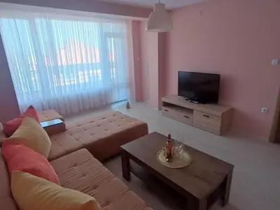 a living room with a couch and a tv at Apartament Lili Sozopol in Sozopol