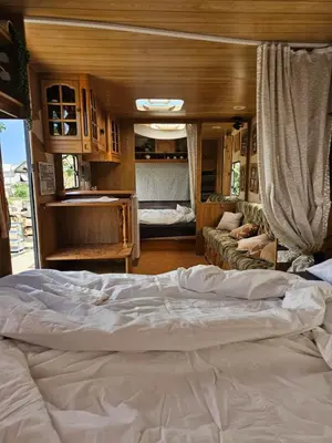 a bedroom with a large bed in a rv at Beachfront Caravans in Chernomorets