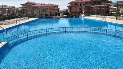 a large pool of blue water with buildings in the background at Studio Sorrento Sole Mare-Bastet BS in Sveti Vlas