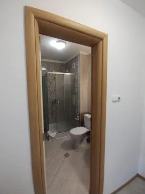 a bathroom with a shower and a toilet in it at Apartament Messambria Resort - Bastet BS in Sunny Beach