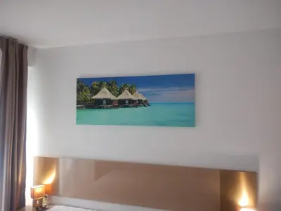 a hotel room with a picture of the ocean at Apartament Messambria Resort - Bastet BS in Sunny Beach