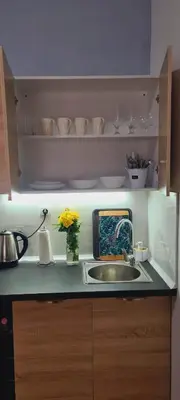 a kitchen counter with a sink and a vase of flowers at Apartament Sorrento in Marina Cape in Aheloy