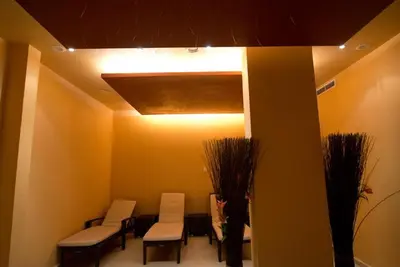 a waiting room with chairs and tables and a light at Apartament Sorrento in Marina Cape in Aheloy