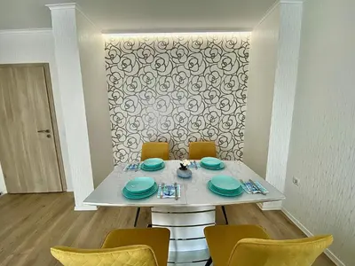a white table with chairs and plates on it at AVRORA in Varna City